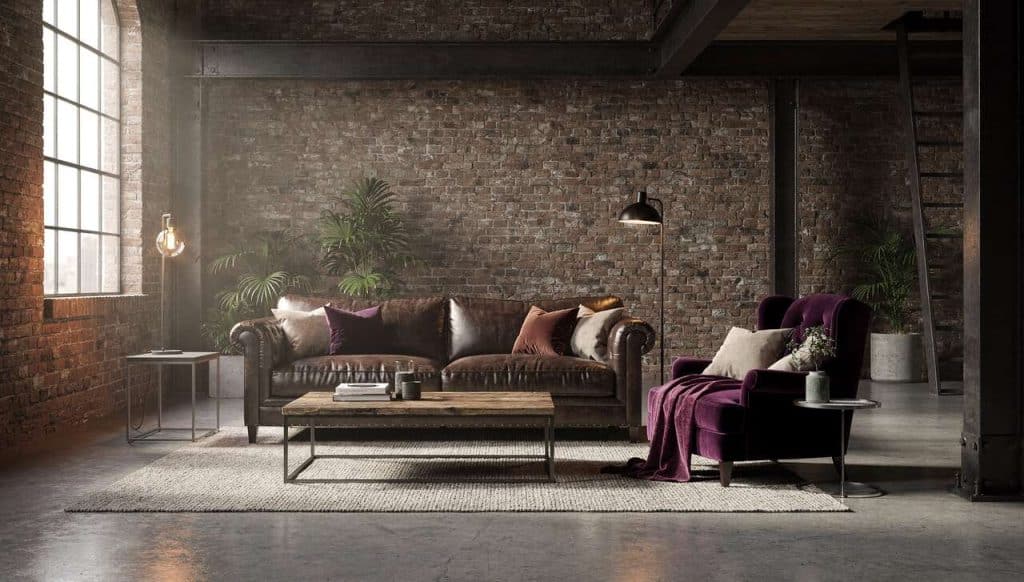 Comment associer canapé, fauteuil et matières brutes dans un salon esprit atelier ?